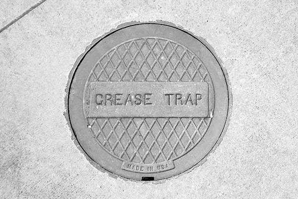 foul odors, slow drainage, and visible grease buildup are signs that your grease trap needs pumping